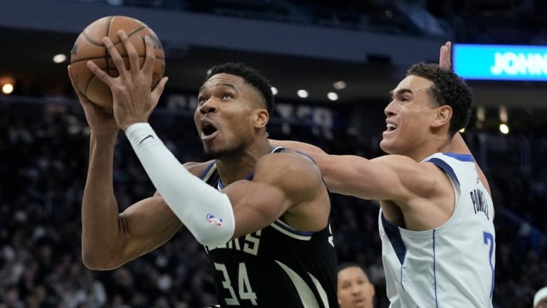 Milwaukee Bucks' Giannis Antetokounmpo drives past Dallas Mavericks' Dwight Powell during the second half of an NBA basketball game Saturday, Nov. 18, 2023, in Milwaukee. (Morry Gash/AP Photo)