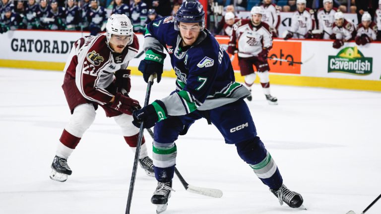 Seattle Thunderbirds forward Jordan Gustafson, right, takes the puck past Peterborough Petes forward Tucker Robertson during first period semifinal CHL Memorial Cup hockey action in Kamloops, B.C., Friday, June 2, 2023. (Jeff McIntosh/CP)