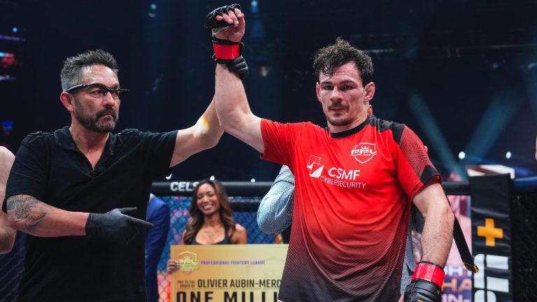 Referee Mario Yamasaki raises Olivier Aubin-Mercier’s hand in victory in Washington on Saturday, Nov. 25, 2023, after the Canadian won the PFL lightweight title and US$1 million for the second year in a row. (CP/HO/Professional Fighters League-Cooper Neil)