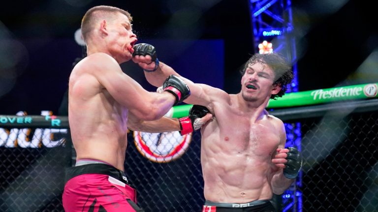 Marcin Held, left, and Olivier Aubin-Merciert, right, trade punches during a Professional Fighters League bout in Atlantic City, N.J., Thursday, June 10, 2021. (Matt Rourke/AP Photo)