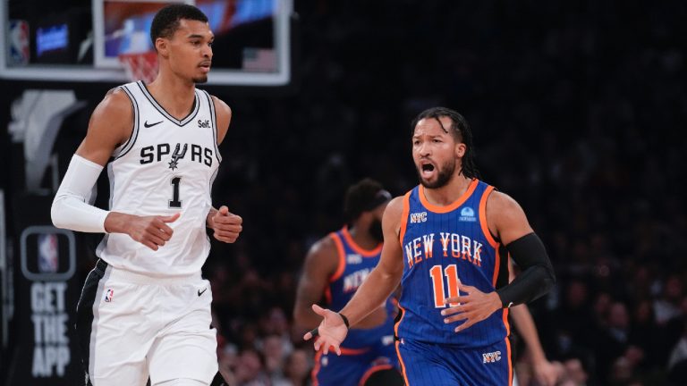 New York Knicks' Jalen Brunson, right, reacts as San Antonio Spurs' Victor Wembanyama looks on during the first half of an NBA basketball game, Wednesday, Nov. 8, 2023, in New York. (Seth Wenig/AP)