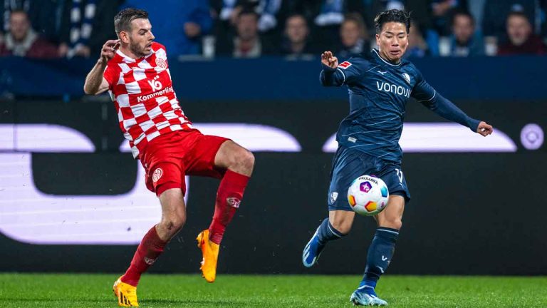 Maxim Leitsch of Mainz, left, and Bochum's Takuma Asano battle for the ball during the Bundesliga soccer match between VfL Bochum and FSV Mainz 05 at Vonovia Ruhrstadion, Bochum. (David Inderlied/AP)