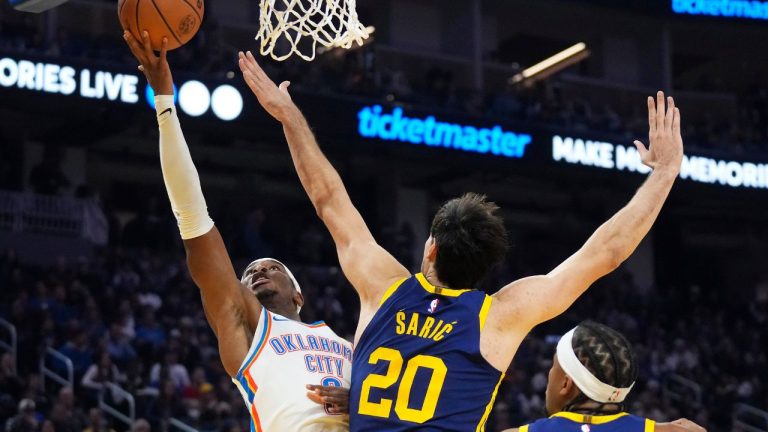 Oklahoma City Thunder guard Shai Gilgeous-Alexander shoots against Golden State Warriors forward Dario Saric during the first half of an NBA basketball game in San Francisco, Saturday, Nov. 18, 2023. (Jeff Chiu/AP Photo)