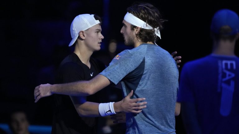 Greece's Stefanos Tsitsipas, right, embraces Denmark's Holger Rune after injuring during the singles tennis match of the ATP World Tour Finals at the Pala Alpitour, in Turin, Italy, Tuesday, Nov. 14, 2023. (Antonio Calanni/AP)