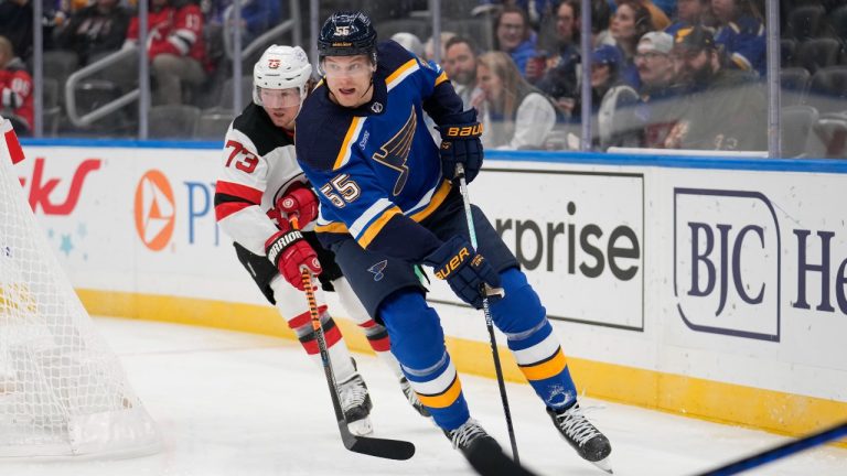 St. Louis Blues' Colton Parayko (55) handles the puck as New Jersey Devils' Tyler Toffoli (73) defends during the first period of an NHL hockey game Friday, Nov. 3, 2023, in St. Louis. (Jeff Roberson/AP Photo)