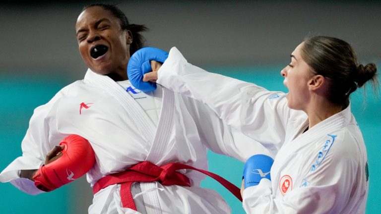 Colombia's Wendy Mosquera, left, and Canada's Melissa Bratic compete in women's karate -68Kg bout at the Pan American Games in Santiago, Chile, Sunday, Nov. 5, 2023. (Moises Castillo/AP)