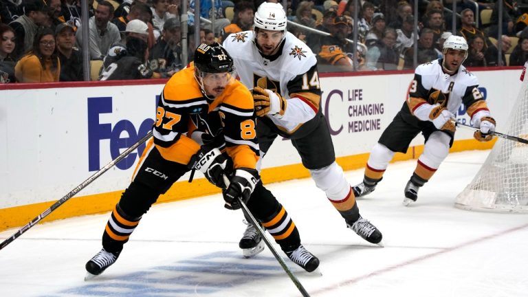 Pittsburgh Penguins' Sidney Crosby (87) sets up a goal with a pass in front of Vegas Golden Knights' Nicolas Hague (14) during the second period of an NHL hockey game in Pittsburgh, Thursday, Dec. 1, 2022. (Gene J. Puskar/AP)
