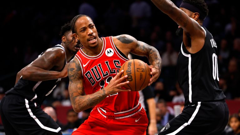 Chicago Bulls forward DeMar DeRozan, center, drives to the basket against Brooklyn Nets forward Royce O'Neale, right, during the second half of an NBA basketball game, Sunday, Nov. 26, 2023, in New York. (Noah K. Murray/AP)