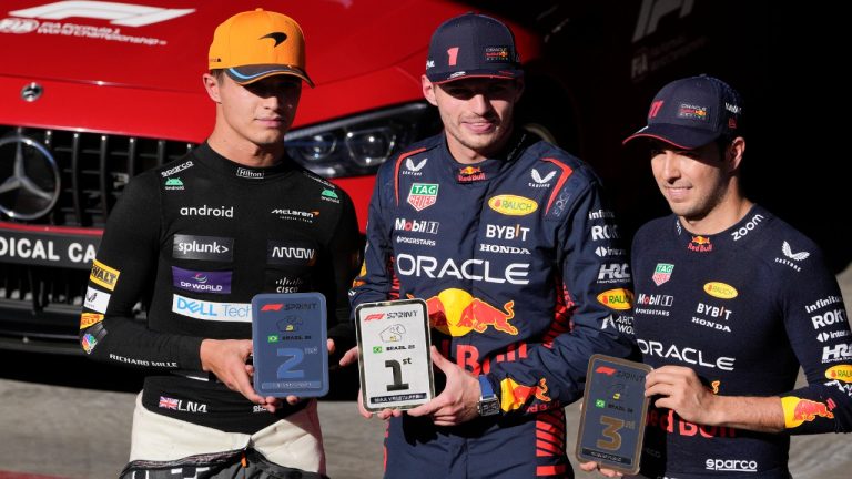 Sprint winners from left, McLaren driver Lando Norris of Britain, second place, Red Bull driver Max Verstappen of the Netherlands, first place, and Red Bull driver Sergio Perez of Mexico, third place, pose for photos a day ahead of the Brazilian Formula One Grand Prix, at the Interlagos racetrack in Sao Paulo, Brazil, Saturday, Nov. 4, 2023. (Andre Penner/AP)