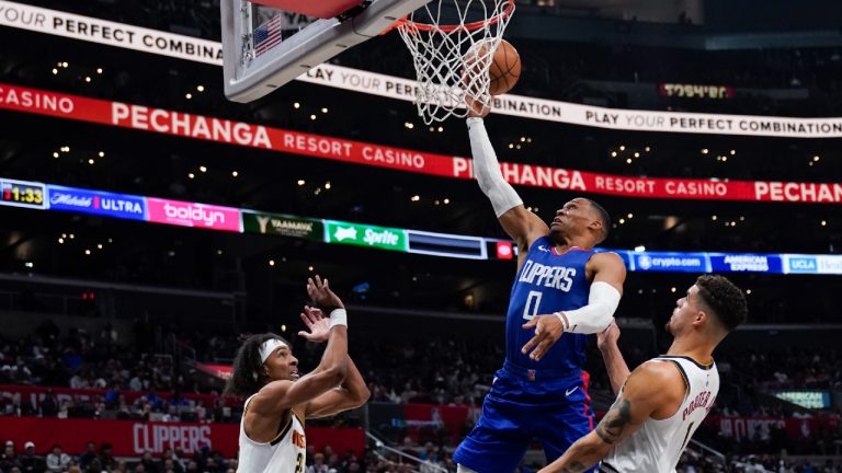 Los Angeles Clippers guard Russell Westbrook, center, shoots against Denver Nuggets forwards Zeke Nnaji, left, and Michael Porter Jr. during the second half of an NBA basketball game, Monday, Nov. 27, 2023, in Los Angeles. (Ryan Sun/AP)