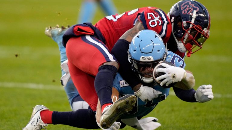 Toronto Argonauts running back AJ Ouellette (34) gets taken down by Montreal Alouettes linebacker Tyrice Beverette (26) during first half CFL Eastern Division final football action in Toronto, Saturday, Nov. 11, 2023. (Frank Gunn/CP)