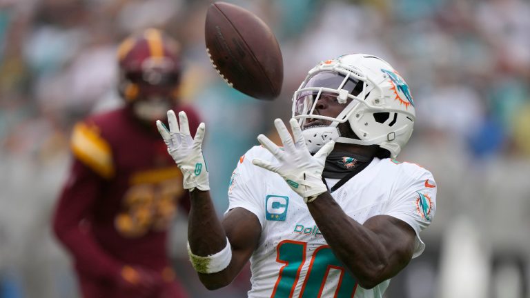 Miami Dolphins wide receiver Tyreek Hill (10) catches a touchdown pass during the first half of an NFL football game against the Washington Commanders Sunday, Dec. 3, 2023, in Landover, Md. (Mark Schiefelbein/AP)