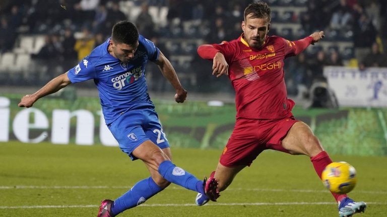 Empoli's Nicolo Cambiaghi, left, kicks the ball past Lecce's Marin Pongracic during the Serie A soccer match between Empoli and Lecce at the Castellani stadium in Empoli, Italy, Monday, Dec. 11, 2023. (Marco Bucco/LaPresse via AP)