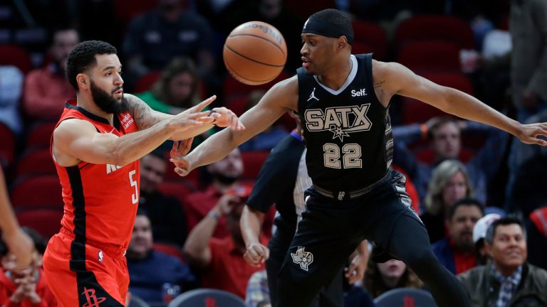 Houston Rockets guard Fred VanVleet, left, passes the ball in front of San Antonio Spurs guard Malaki Branham (22) during the first half of an NBA basketball game, Monday, Dec. 11, 2023, in Houston. (Michael Wyke/AP)