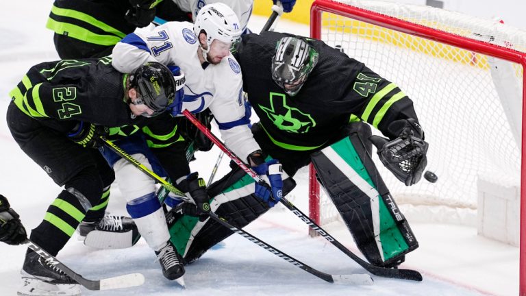 Tampa Bay Lightning center Anthony Cirelli (71) scores against Dallas Stars goaltender Scott Wedgewood (41) as center Roope Hintz (24) helps defend on the play in the third period of an NHL hockey game, Saturday, Feb. 11, 2023, in Dallas. (AP Photo/Tony Gutierrez) 