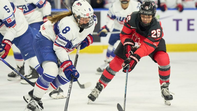 Team USA's Haley Winn, left, and Canada's Emily Clark fight for control of the puck during the Canada USA Rivalry series in Kitchener, Ontario on Thursday, December 14, 2023. (Geoff Robins/CP)