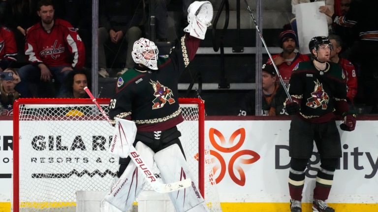 Arizona Coyotes goaltender Connor Ingram (39) and Coyotes defenseman J.J. Moser, right, begin to celebrate after a shutout win over the Washington Capitals in the closing seconds of the third period of an NHL hockey game Monday, Dec. 4, 2023, in Tempe, Ariz. (Ross D. Franklin/AP)