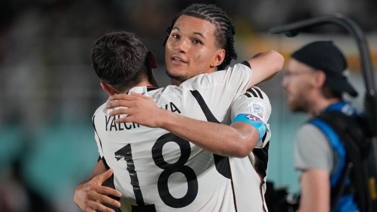 Germany's Paris Brunner, right, celebrates with teammate Bilal Yalcinkaya after defeating France in a penalty shootout during their U-17 World Cup final soccer match at Manahan Stadium in Surakarta, Indonesia, Saturday, Dec. 2, 2023. (AP Photo/Achmad Ibrahim)