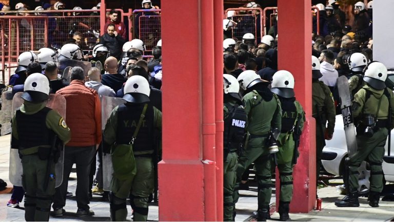 Riot police detain dozens of fans outside the Melina Merkouri indoor stadium, in western Athens, early Friday, Dec. 8, 2023. A Greek policeman has been severely injured as a mob of volleyball fans poured out of an Athens arena and attacked riot police. A flare shot by a fan severed an artery in the thigh of the 30-year-old officer Thursday night. (Yorgos Matthaios/Eurokinissi Sports via AP)