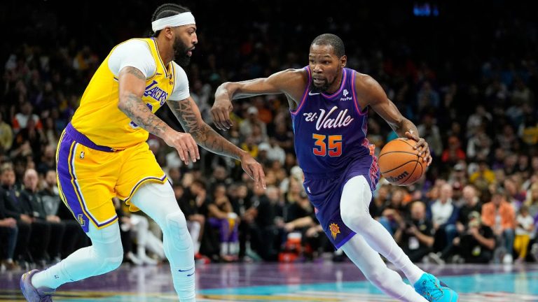 Phoenix Suns forward Kevin Durant drives on Los Angeles Lakers forward Anthony Davis during the first half of an NBA basketball game, Friday, Nov. 10, 2023, in Phoenix. (Matt York/AP Photo)