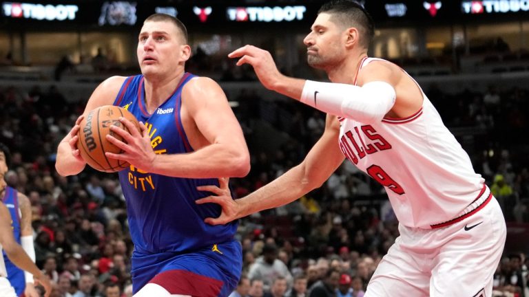 Denver Nuggets center Nikola Jokic drives to the basket past Chicago Bulls center Nikola Vucevic during the first half of an NBA basketball game Tuesday, Dec. 12, 2023, in Chicago. (Charles Rex Arbogast/AP)