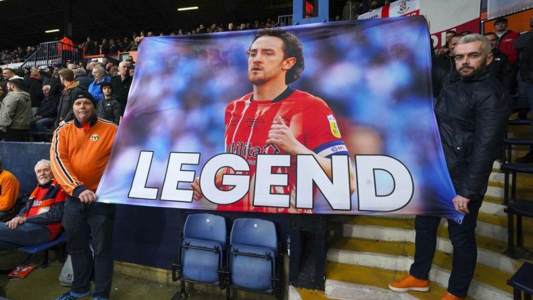 Luton Town fans hold up a banner of support for Tom Lockyer during the English Premier League soccer match between Luton Town and Newcastle United at Kenilworth Road, Luton, England, Saturday, Dec. 23, 2023. (Nick Potts/PA via AP)