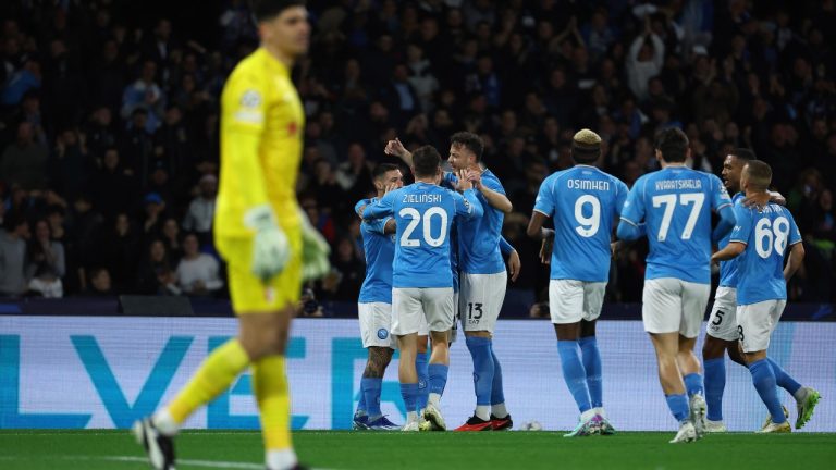 Napoli's Matteo Politano celebrates with teammates after scoring the first goal of the game during the Champions League group C soccer match between Napoli and Braga at the Diego Armando Maradona stadium in Naples, Italy, Tuesday, Dec. 12, 2023. (Alessandro Garofalo/LaPresse via AP)