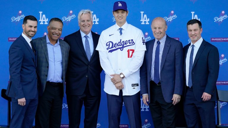 Los Angeles Dodgers' Shohei Ohtani (17) poses for photos with Brandon Gomes, from left, manager Dave Roberts, owner & chairman Mark Walter, President & CEO Stan Kasten and president of baseball operations Andrew Friedman during a baseball news conference at Dodger Stadium Thursday, Dec. 14, 2023, in Los Angeles. (Ashley Landis/AP)