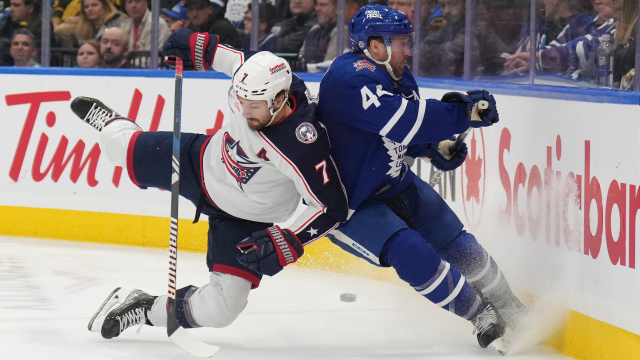 Columbus-Blue-Jackets-centre-Sean-Kuraly-(7)-checks-Toronto-Maple-Leafs-defenceman-Morgan-Rielly-(44)-during-third-period-NHL-hockey-action-in-Toronto-on-Thursday,-December-14,-2023.-(Nathan-Denette/CP)