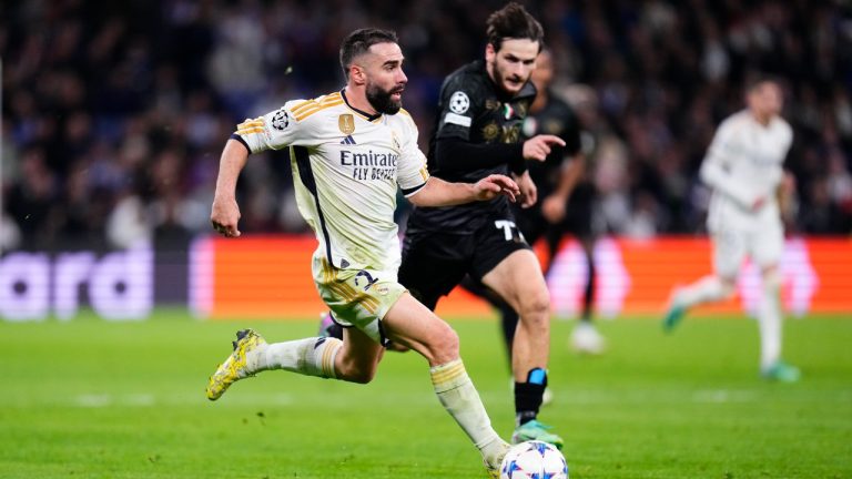 Real Madrid's Dani Carvajal, left, and Napoli's Khvicha Kvaratskhelia challenge for the ball during the Champions League Group C soccer match between Real Madrid and Napoli at the Santiago Bernabeu stadium in Madrid, Spain, Wednesday, Nov. 29, 2023. (Manu Fernandez/AP)