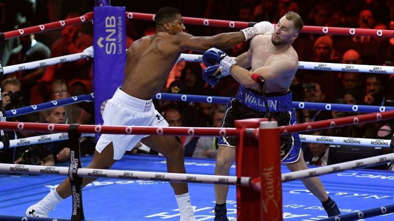 Anthony Joshua, left, and Otto Wallin fight during a boxing match at Kingdom Arena in Riyadh, Saudi Arabia, early Sunday, Dec. 24, 2023. (AP Photo)