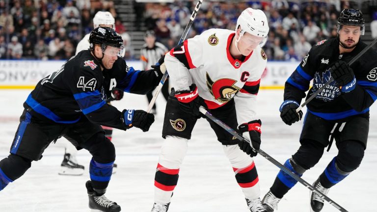 Ottawa Senators' Brady Tkachuk (7) protects the puck from Toronto Maple Leafs' Morgan Rielly (44) and Auston Matthews (34) during first period NHL hockey action in Toronto on Wednesday, December 27, 2023. (Frank Gunn/CP)