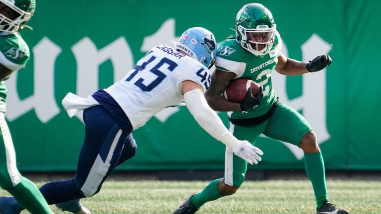 Saskatchewan Roughriders kick returner Mario Alford is tackled by Toronto Argonauts linebacker Jack Cassar during the first half of CFL football action in Regina, Sask., on Saturday, October 21, 2023. (Heywood Yu/CP Photo)