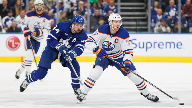 Toronto Maple Leafs centre Auston Matthews chases Edmonton Oilers centre Connor McDavid during first period NHL hockey action in Toronto on Saturday, Mar. 11, 2023. (Cole Burston/CP Photo)