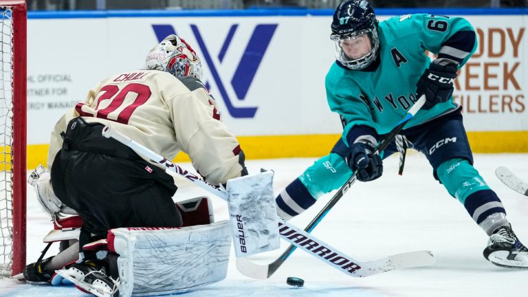 Montreal's goaltender Elaine Chuli (20) stops a shot on goal by New York's Emma Woods (67) during the second period of a PWHL hockey game Wednesday, Jan. 10, 2024, in Elmont, N.Y. (AP Photo/Frank Franklin II)