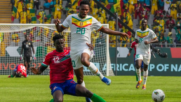 Senegal's Habib Diallo, right, tussles for the ball with Gambia's James Gomez during the African Cup of Nations Group C soccer match between Senegal and Gambia at the Charles Konan Banny stadium in Yamoussoukro, Ivory Coast, Monday, Jan. 15, 2024. (Sunday Alamba/AP) 