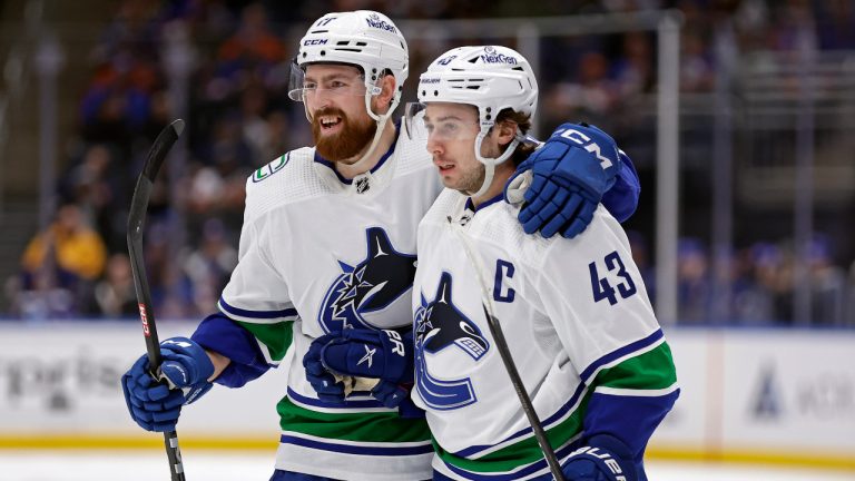 Vancouver Canucks defenseman Quinn Hughes (43) is congratulated by Filip Hronek for a goal against the New York Islanders during the first period of an NHL hockey game Tuesday, Jan. 9, 2024, in Elmont, N.Y. (Adam Hunger/AP) 