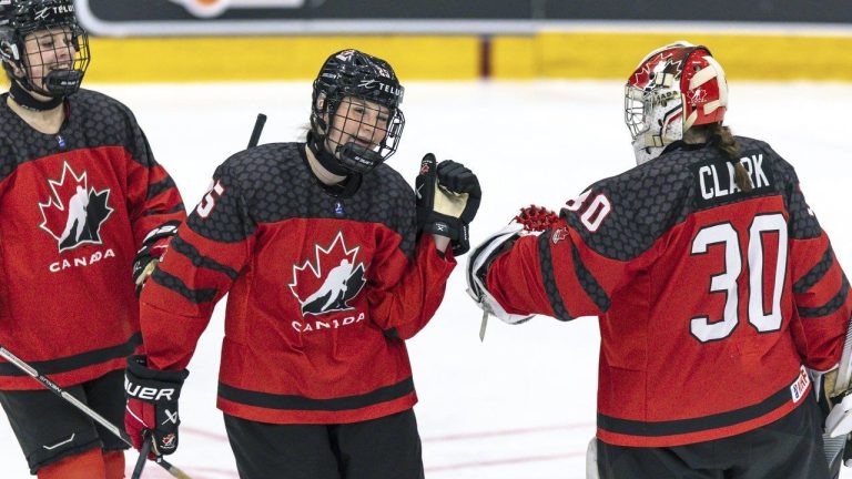 Canada's Gracie Graham, centre, reacts with goalkeeper Hannah Clark, right, during the Women's U18 Ice Hockey World Championship match between Canada and Sweden, in Ostersund, Sweden, Sunday, Jan. 15, 2023. Graham had a goal and two assists as Canada advanced to the semifinals of the world women's under-18 hockey championship with a 6-0 win over host Switzerland on Thursday. (Per Danielsson-TT News Agency via AP)