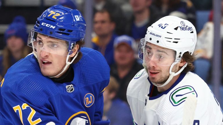 Buffalo Sabres right wing Tage Thompson (72) and Vancouver Canucks defenseman Quinn Hughes (43) battle for position in front of the net during the first period of an NHL hockey game Saturday, Jan. 13, 2024, in Buffalo, N.Y. (AP/Jeffrey T. Barnes)
