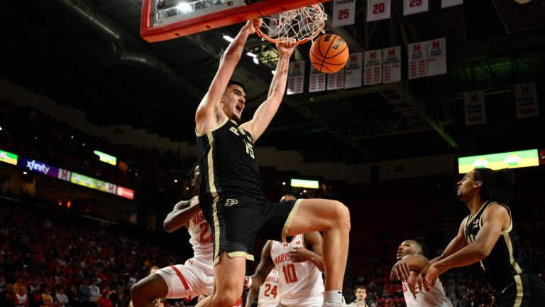Purdue centre Zach Edey (15) dunks over Maryland forward Jordan Geronimo (22), forward Julian Reese (10) and guard Jahmir Young, second from right, during the first half of an NCAA college basketball game Tuesday, Jan. 2, 2024, in College Park, Md. (Nick Wass/AP)