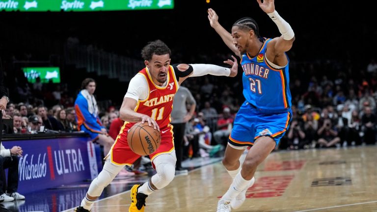 Atlanta Hawks guard Trae Young (11) drives as Oklahoma City Thunder guard Aaron Wiggins (21) defends during the first half of an NBA basketball game Wednesday, Jan. 3, 2024, in Atlanta. (AP Photo/John Bazemore)