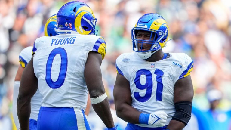 Los Angeles Rams linebacker Byron Young (0) and defensive tackle Kobie Turner (91) celebrate a sack against the Seattle Seahawks during the second half of an NFL football game, Sunday, Sept. 10, 2023, in Seattle. (AP Photo/Lindsey Wasson)