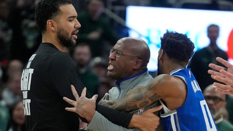Sacramento Kings head coach Mike Brown is restrained by Malik Monk as he argues a call during the second half of an NBA basketball game against the Milwaukee Bucks Sunday, Jan. 14, 2024, in Milwaukee.  (Morry Gash/AP Photo)