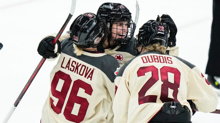 Montreal's Marie-Philip Poulin, center, celebrates with teammates Montreal's Dominika Laskova, left, and Catherine Dubois, right, after scoring an empty-net goal during the third period of a PWHL hockey game against New York Wednesday, Jan. 10, 2024, in Elmont, N.Y. Montreal won 5-2. (Frank Franklin II/AP)