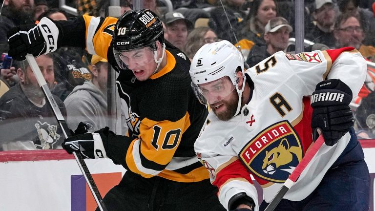 Florida Panthers' Aaron Ekblad (5) clears the puck while defending against Pittsburgh Penguins' Drew O'Connor during the second period of an NHL hockey game in Pittsburgh, Friday, Jan. 26, 2024. (AP Photo/Gene J. Puskar)