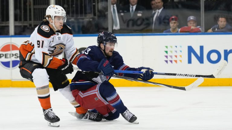 New York Rangers' Alexis Lafreniere, right, slips as he is pursued by Anaheim Ducks' Leo Carlsson during the second period of an NHL hockey game Friday, Dec. 15, 2023, in New York. (Seth Wenig/AP)