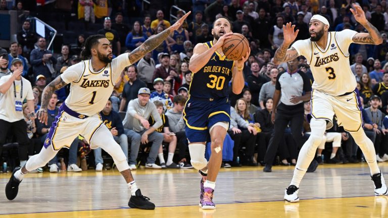 Los Angeles Lakers guard D'Angelo Russell (1) and forward Anthony Davis (3) defend against Golden State Warriors guard Stephen Curry (30) during the second half of an NBA basketball game Saturday, Jan. 27, 2024, in San Francisco. (Nic Coury/AP)
