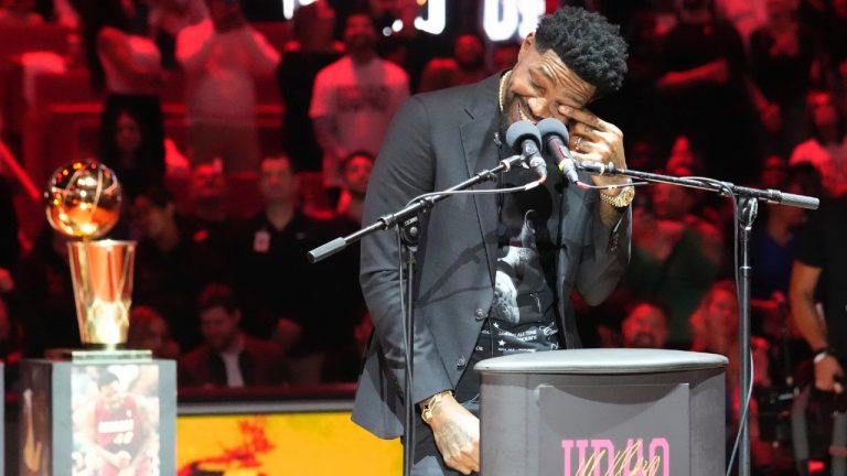 Former Miami Heat player Udonis Haslem wipes a tear during a half time ceremony where his jersey was retired at an NBA basketball game against the Atlanta Hawks, Friday, Jan. 19, 2024, in Miami. (Marta Lavandier/AP)