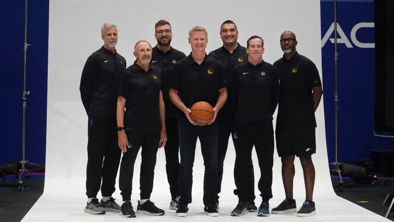 Golden State Warriors head coach Steve Kerr, center, poses for photos with assistants Bruce Fraser, clockwise from top left, Chris DeMarco, Dejan Milojevic, Kris Weems, Kenny Atkinson and Ron Adams during the NBA team's media day in San Francisco, Monday, Oct. 2, 2023. (AP Photo/Jeff Chiu)