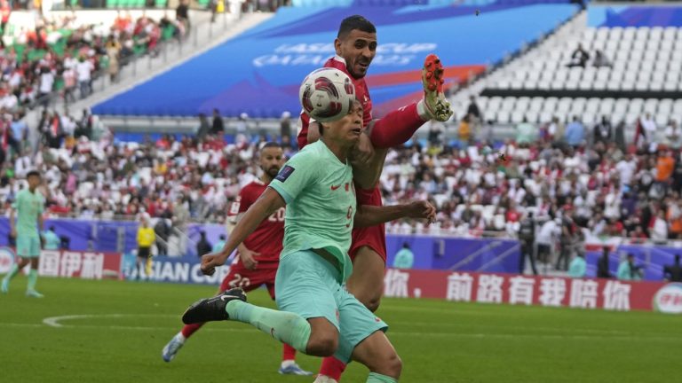Lebanon's Kassem El Zein, right, is challenged by China's Zhang Tun during the Asian Cup Group A soccer match between China and Lebanon at Al Thumama Stadium in Doha, Qatar, Wednesday, Jan. 17, 2024. (Thanassis Stavrakis/AP)